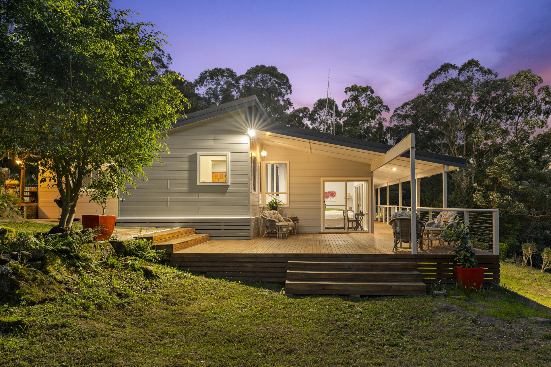 Home exterior and deck at dusk